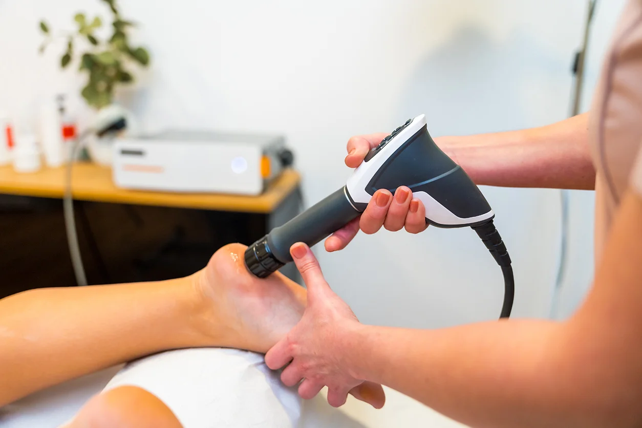 A person getting their foot shaved with an electric device.