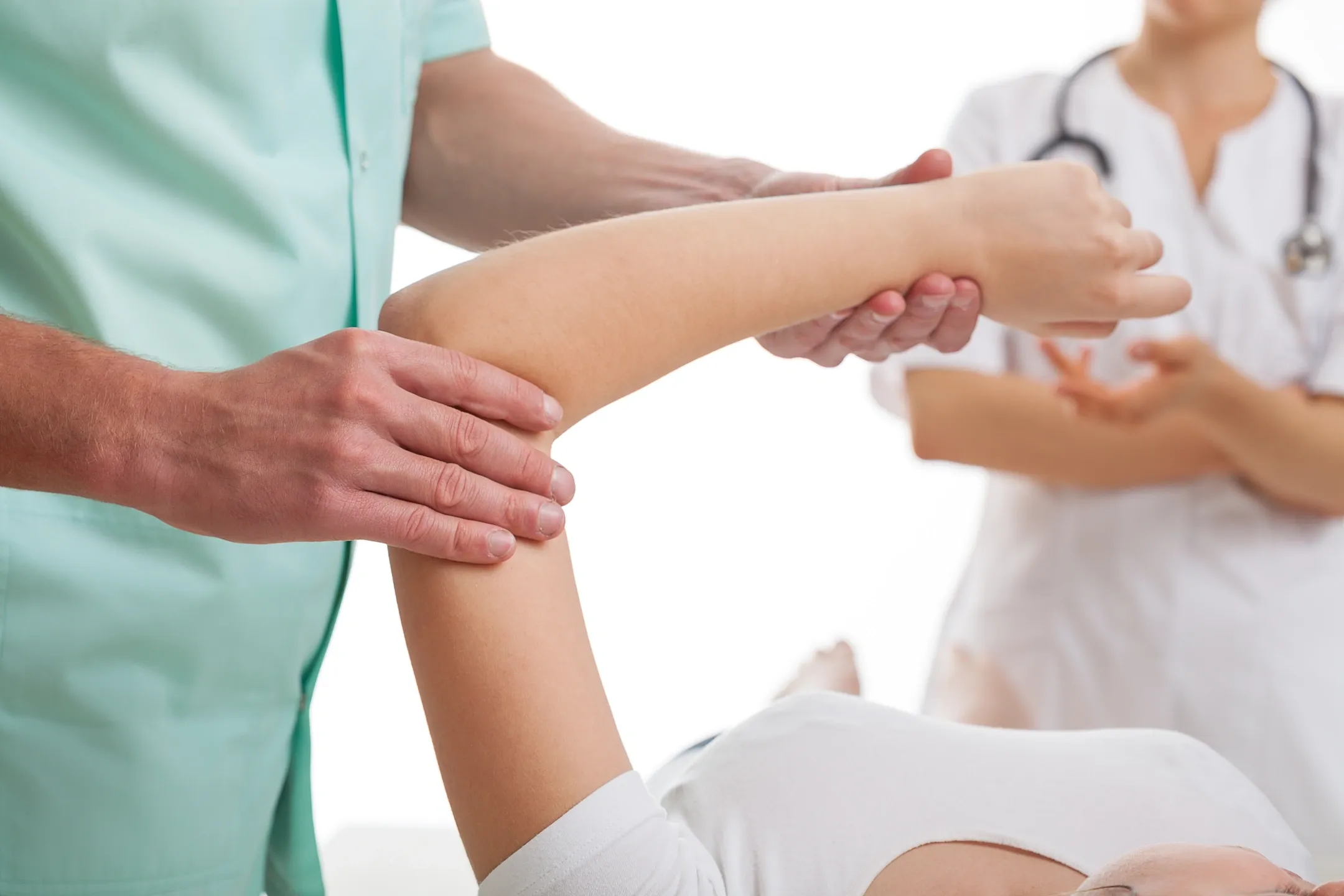 A person is getting their arm examined by an osteopath.