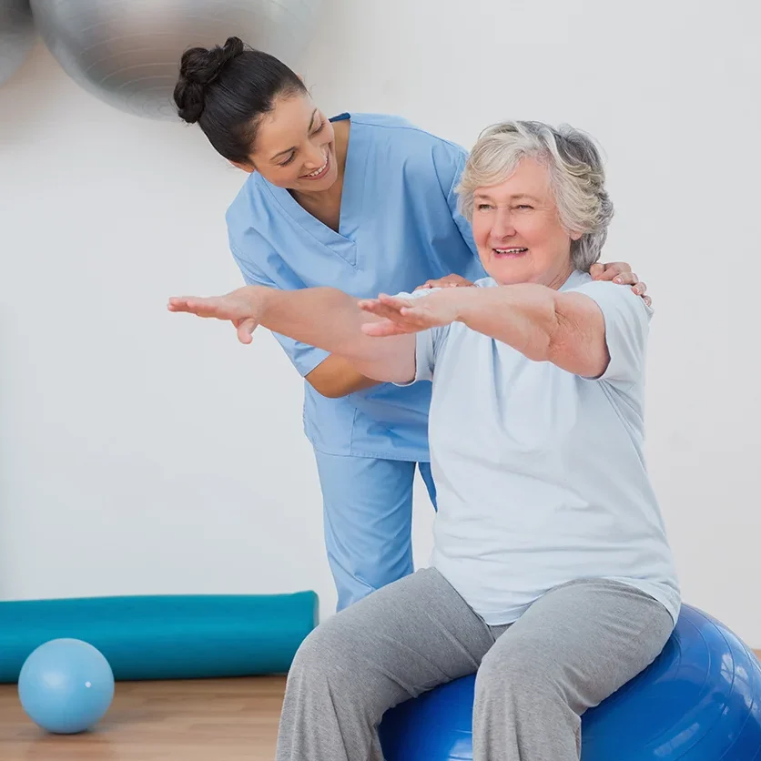 A woman sitting on top of an exercise ball.