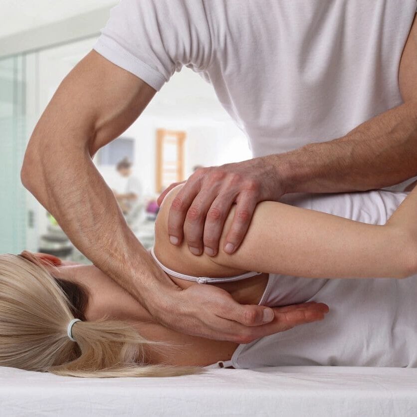 A person is getting their arm worked on by someone else.