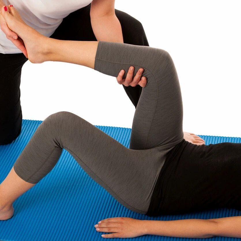 A person is doing some yoga on the floor