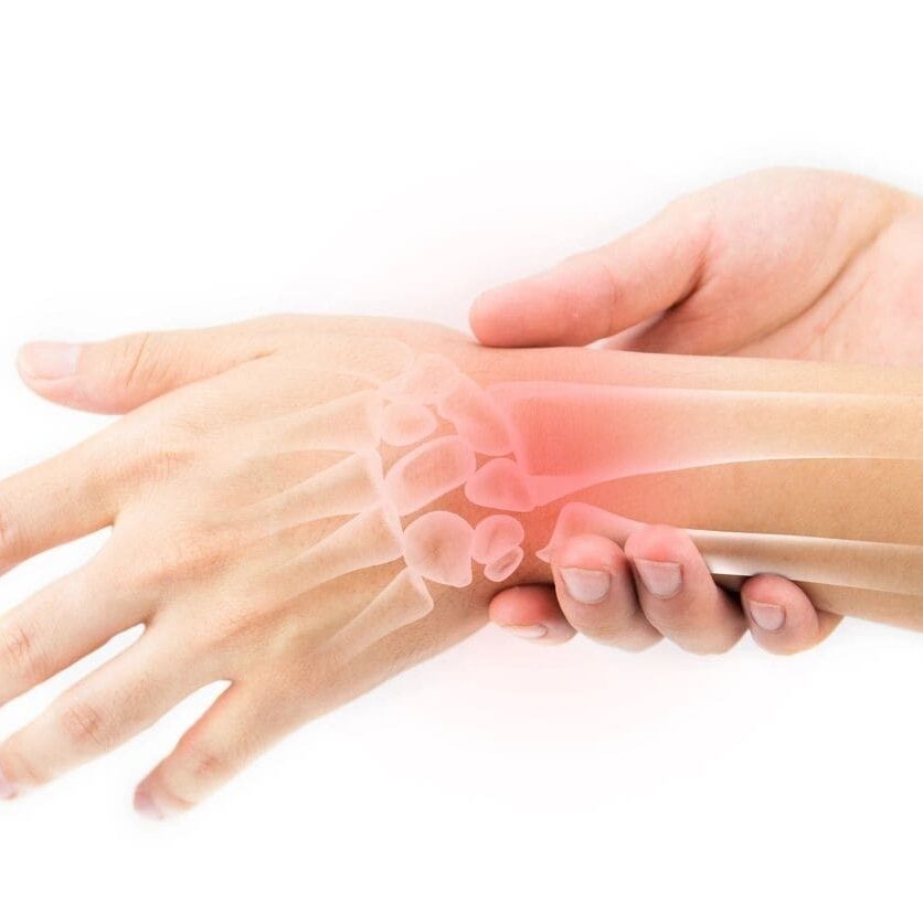 A person with their hands and wrist in pain.