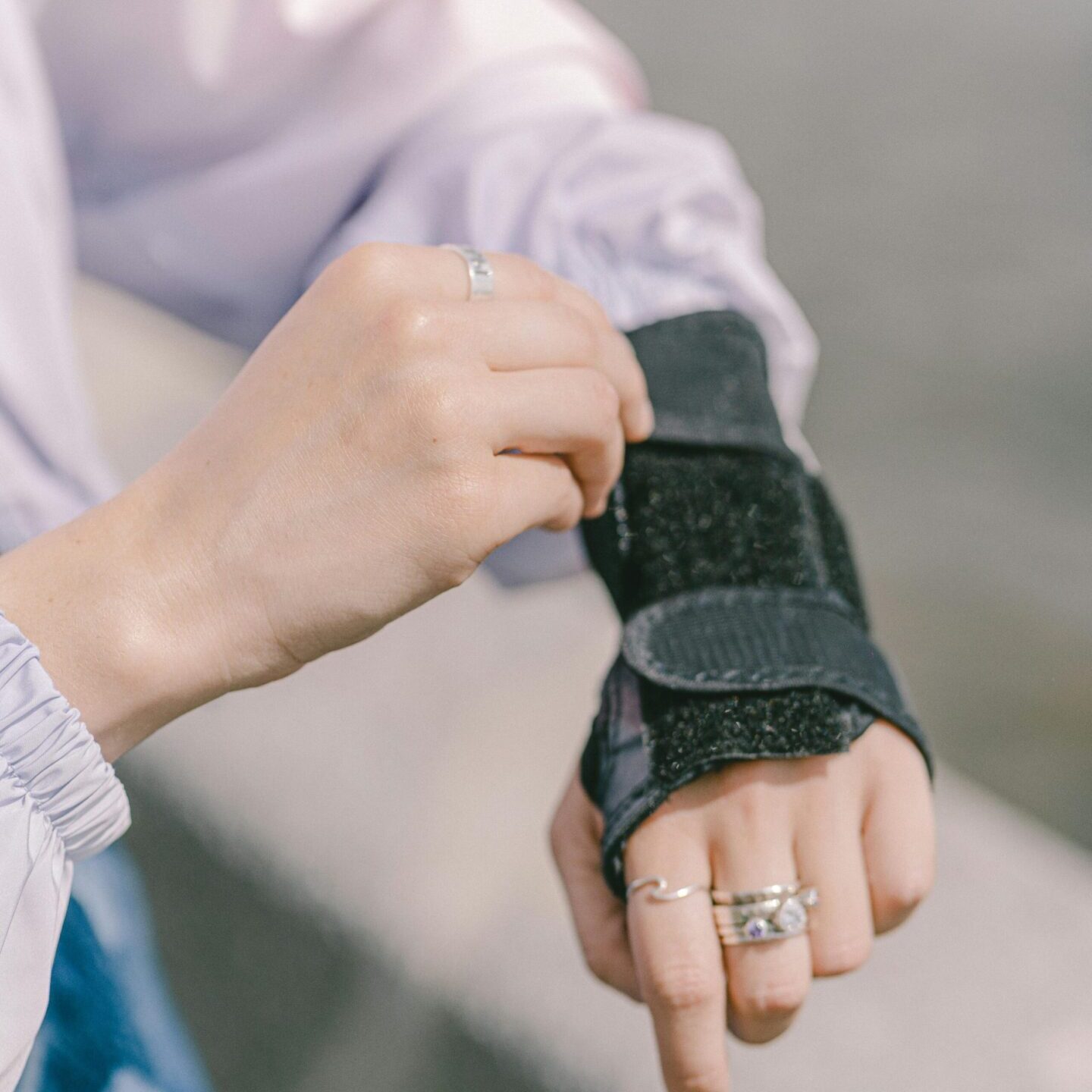 A person with a wrist brace on their hand.